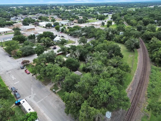 an aerial view of a house with yard