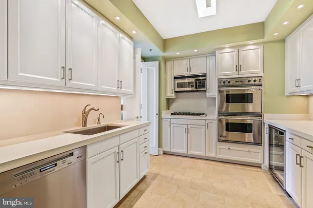 a kitchen with stainless steel appliances granite countertop a refrigerator sink and cabinets