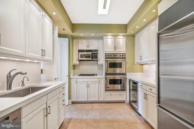 a kitchen with stainless steel appliances a stove sink and cabinets