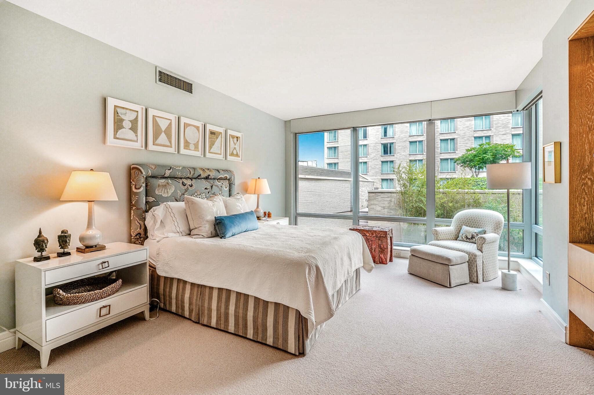 1111 23rd Street Northwest, Unit 4F Washington, DC 20037 - Photo 16 of 27 a bedroom with a bed and a large window