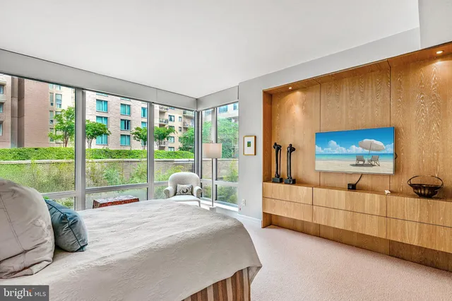 a bed sitting in a bedroom next to a window