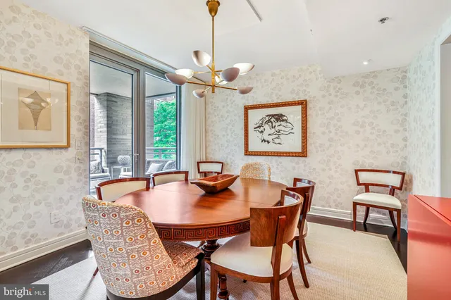 a dining room with furniture a window and a chandelier