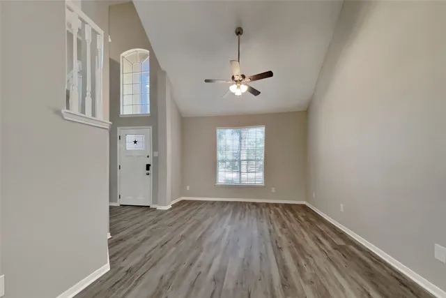 wooden floor in an empty room with a window