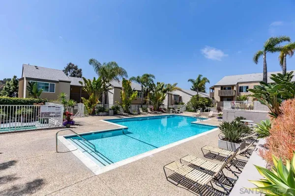 a view of a house with swimming pool and sitting area