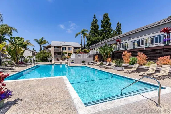 a view of a house with pool and chairs
