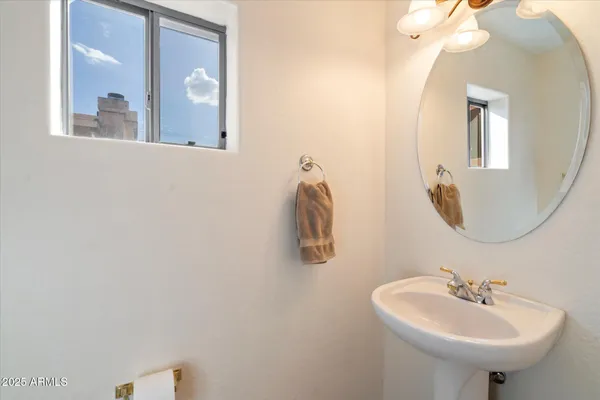 a bathroom with a sink and mirror