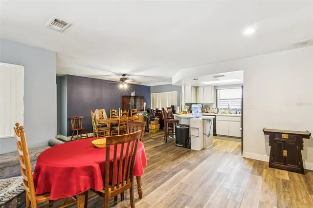 a view of a dining room with furniture and wooden floor