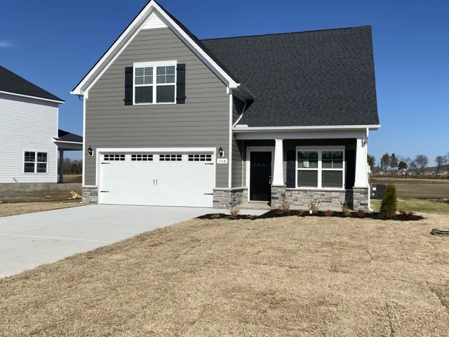 a front view of a house with a yard and garage