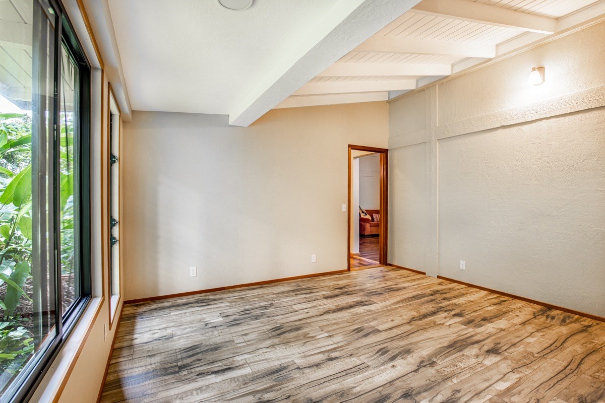 6490 Puupilo Road, Unit A Kapaa, HI 96746 - Photo 27 of 29 a view of an empty room with wooden floor and a window