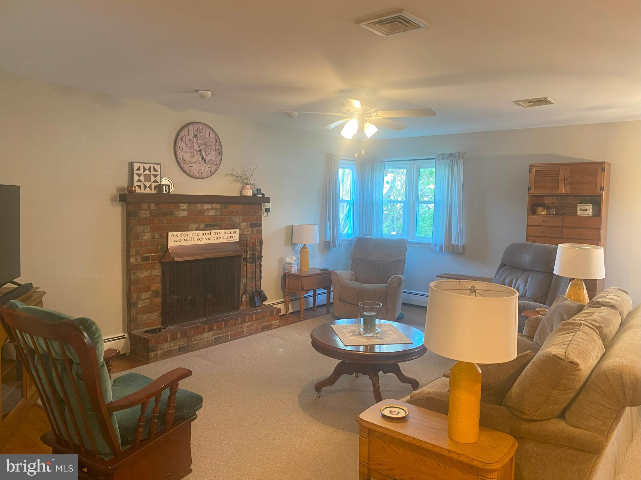 104 Sunnybrook Road Cherry Hill, NJ 08034 - Photo 11 of 39 a living room with furniture a clock and a fireplace