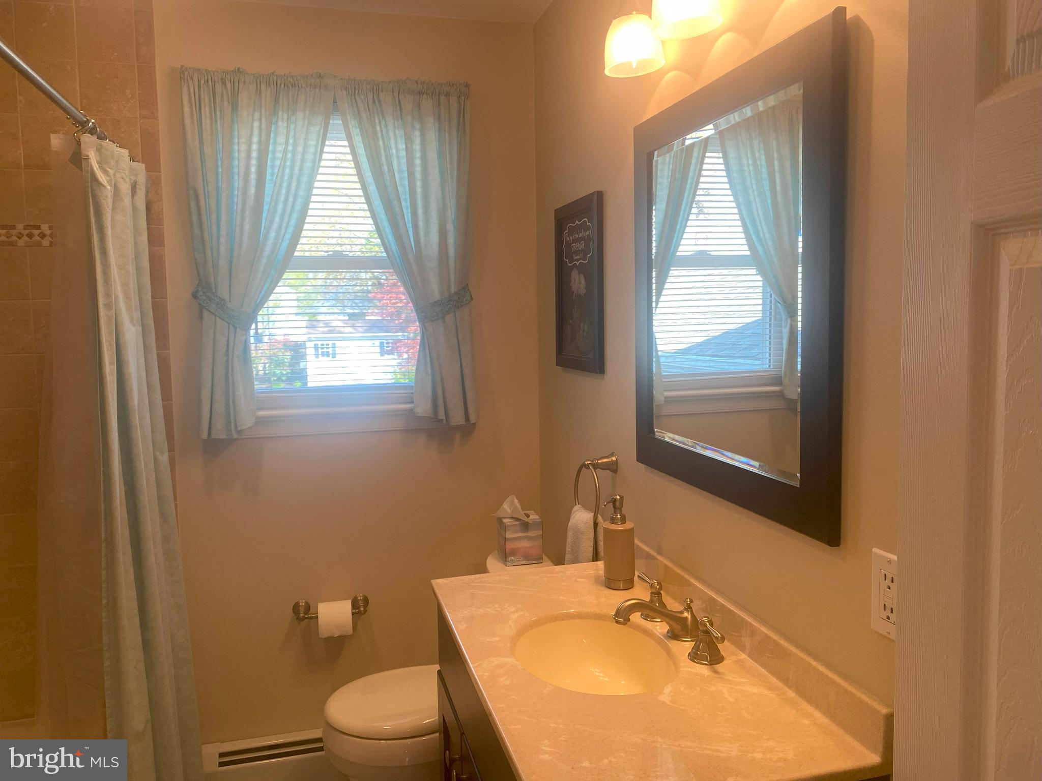 104 Sunnybrook Road Cherry Hill, NJ 08034 - Photo 21 of 39 a bathroom with a sink toilet a mirror and window
