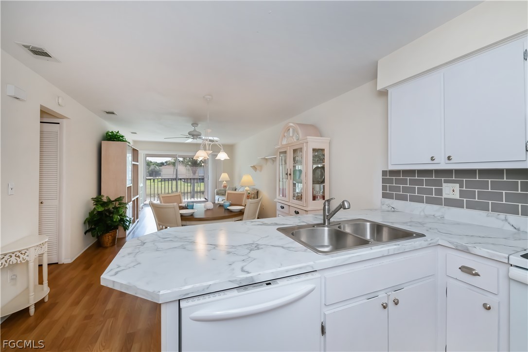 1100 Pondella Road, Unit 514 Cape Coral, FL 33909 - Photo 6 of 34 a kitchen with sink and view living room