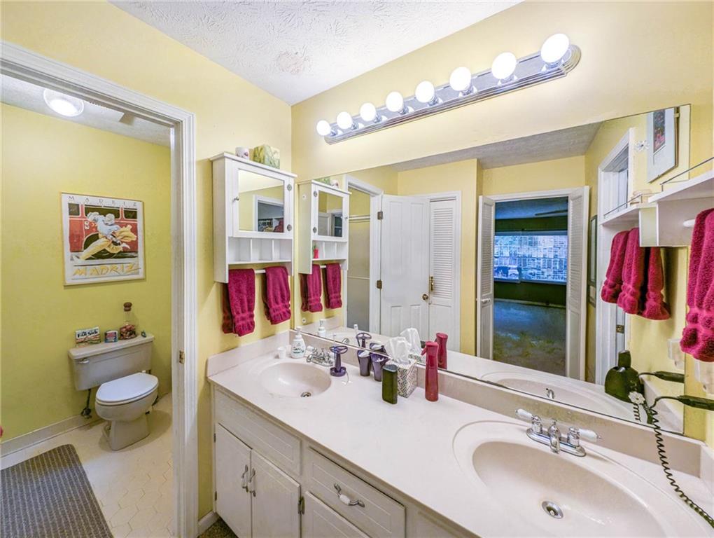 3838 Hunting Ridge Drive Southwest Lilburn, GA 30047 - Photo 30 of 56 a bathroom with a sink double vanity and a mirror