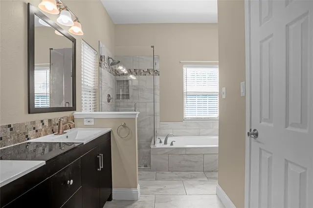 a bathroom with a bathtub and shower