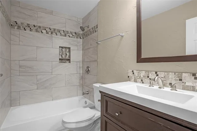 a view of a hallway with wooden floor and stairs