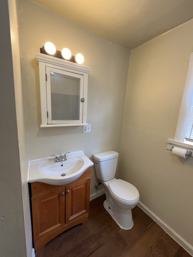 1552 Lombardy Street, Unit 2 Houston, TX 77023 - Photo 14 of 17 a bathroom with a sink a toilet and mirror