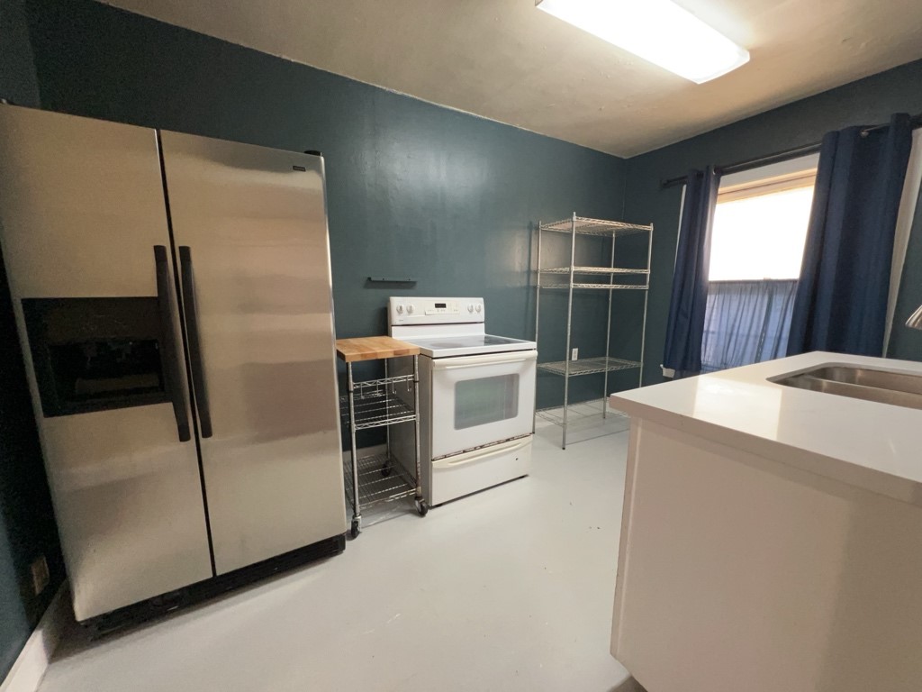 1552 Lombardy Street, Unit 2 Houston, TX 77023 - Photo 8 of 17 a kitchen with a refrigerator sink and stove