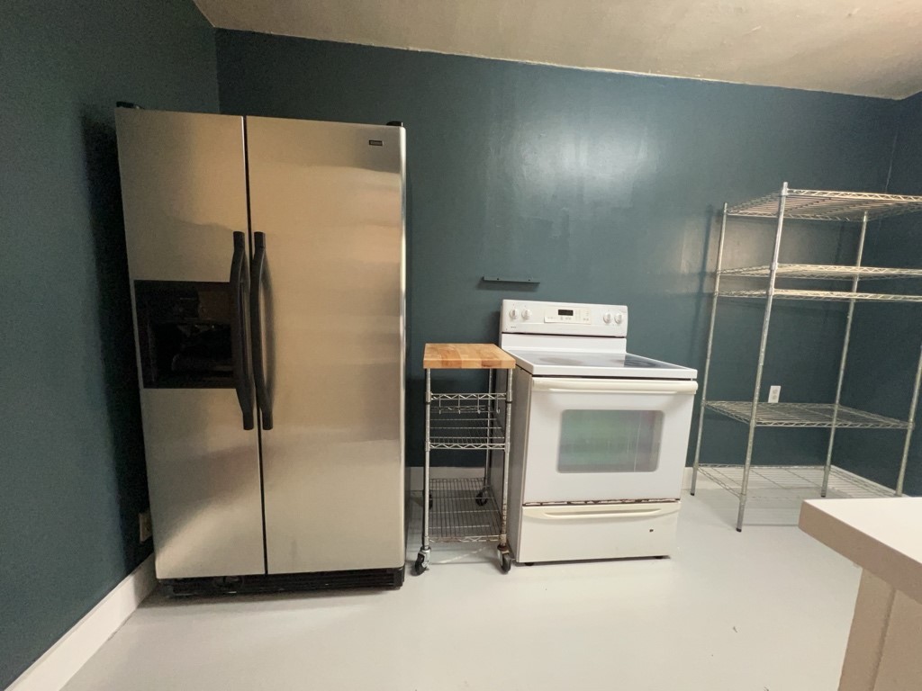 1552 Lombardy Street, Unit 2 Houston, TX 77023 - Photo 10 of 17 a white refrigerator freezer and a stove sitting inside of a kitchen