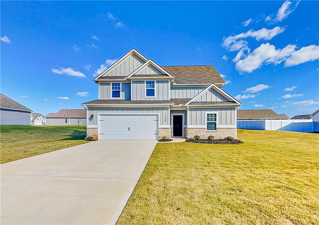 1205 Fendt Drive Locust Grove, GA 30248 - Photo 1 of 19 a front view of a house with a yard
