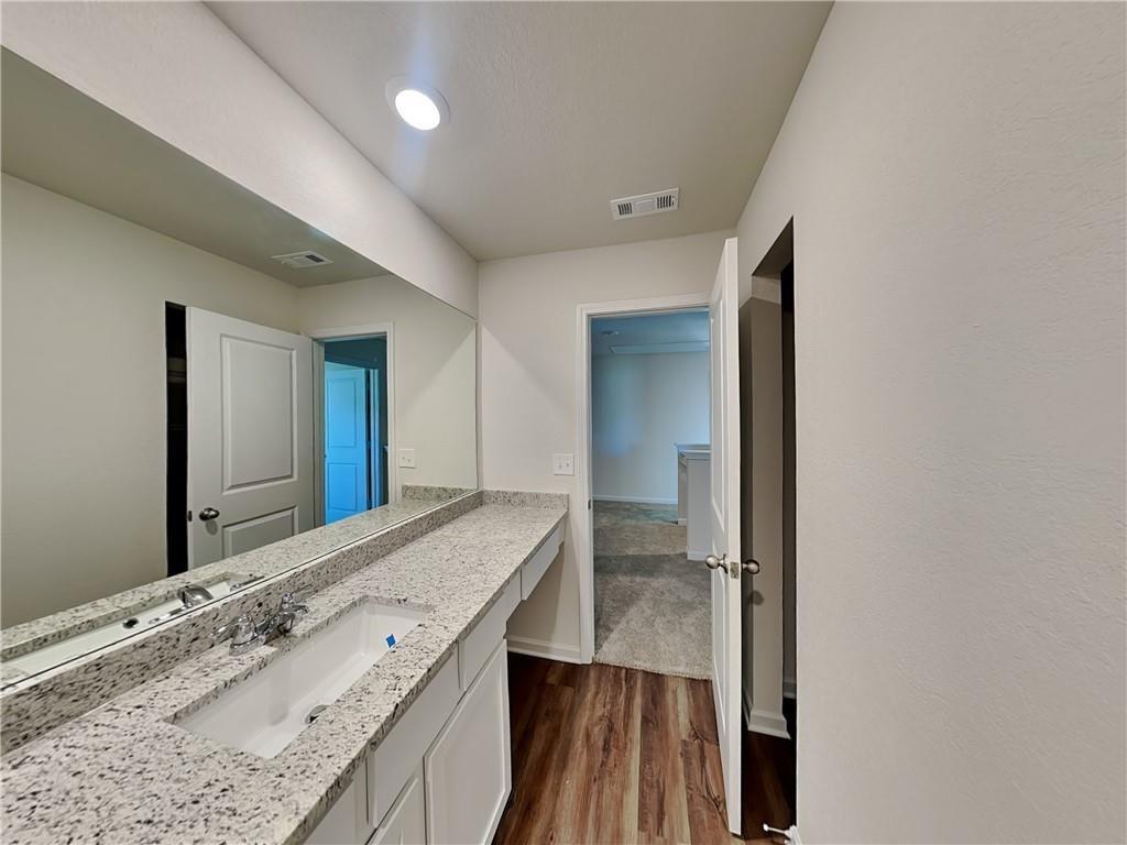 1205 Fendt Drive Locust Grove, GA 30248 - Photo 16 of 19 a bathroom with a granite countertop sink and a mirror
