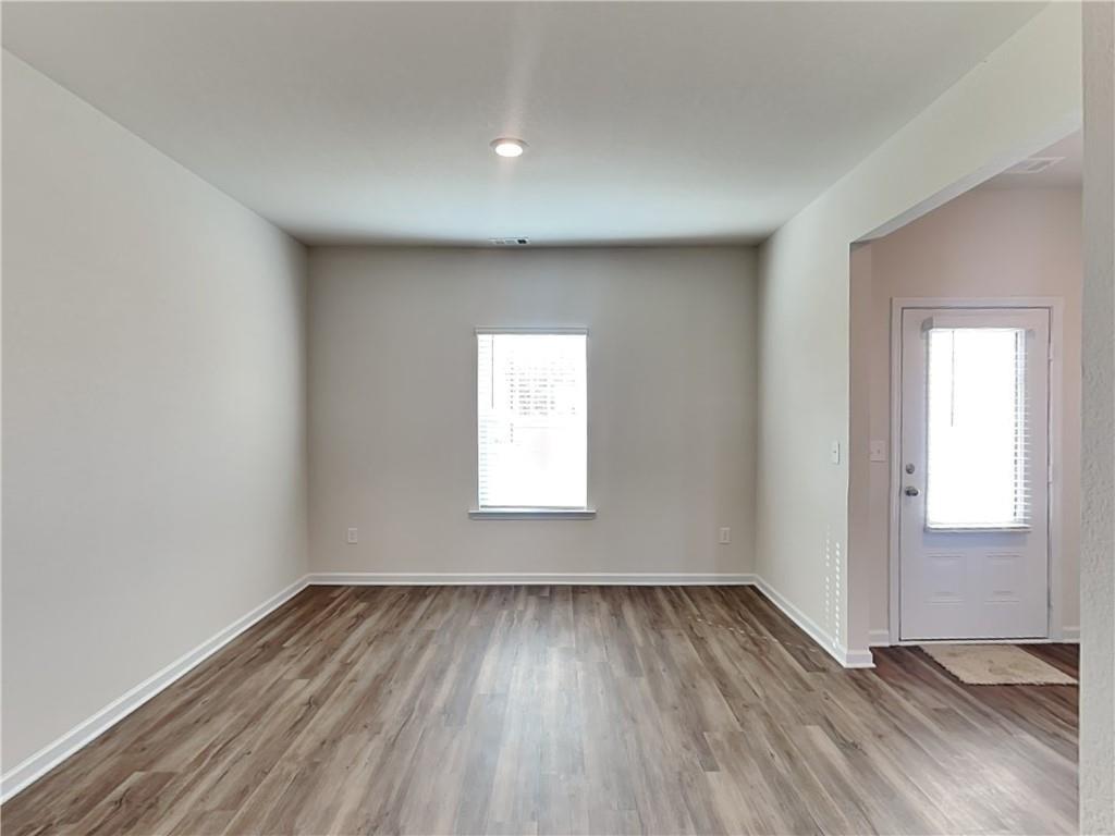 1205 Fendt Drive Locust Grove, GA 30248 - Photo 17 of 19 an empty room with wooden floor and windows
