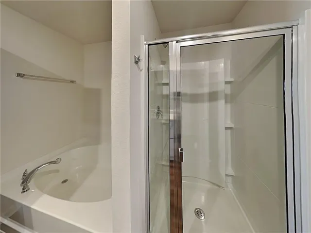 a bathroom with a glass shower door