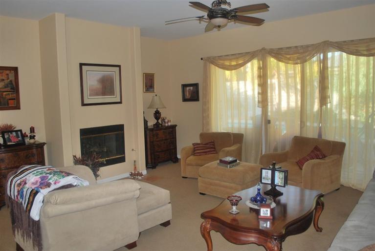 6 Queens Court Rancho Mirage, CA 92270 - Photo 3 of 6 a living room with furniture and a fireplace