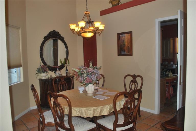 6 Queens Court Rancho Mirage, CA 92270 - Photo 4 of 6 a dining room with furniture and chandelier