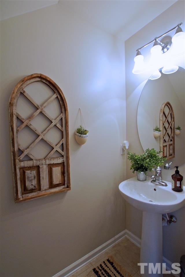 8717 Redcrest Place Raleigh, NC 27617 - Photo 14 of 18 a bathroom with a sink and a mirror