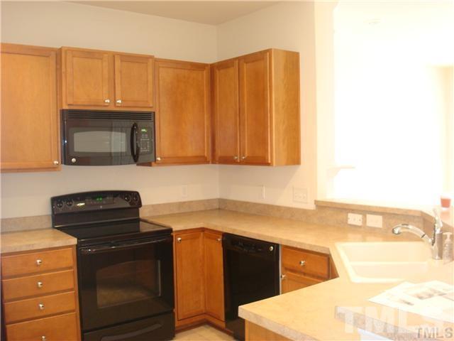 8717 Redcrest Place Raleigh, NC 27617 - Photo 3 of 18 a kitchen with granite countertop a sink cabinets and stainless steel appliances