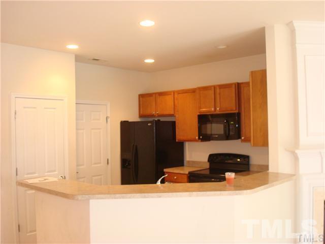 8717 Redcrest Place Raleigh, NC 27617 - Photo 6 of 18 a living room with a couch and a flat screen tv