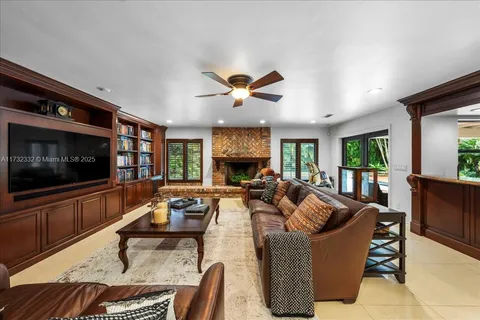 a living room with furniture fireplace and flat screen tv