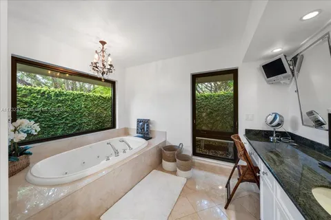 a bathroom with a granite countertop sink a toilet and bathtub