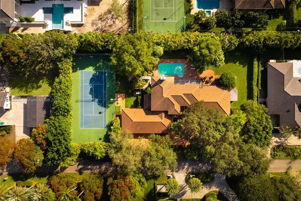 an aerial view of a house with a yard and garden