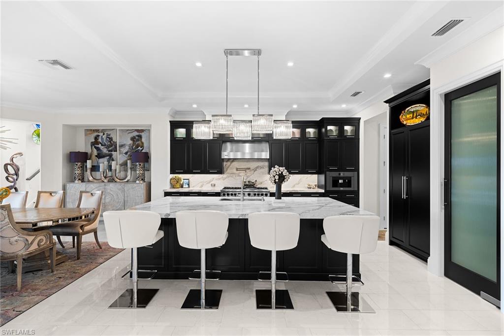 12499 Twin Eagles Boulevard Naples, FL 34120 - Photo 12 of 50 a view of a dining room with furniture