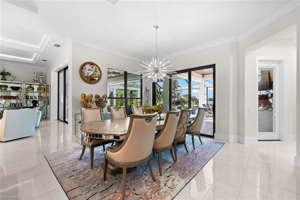 12499 Twin Eagles Boulevard Naples, FL 34120 - Photo 16 of 50 a dining room with furniture a rug and a large window