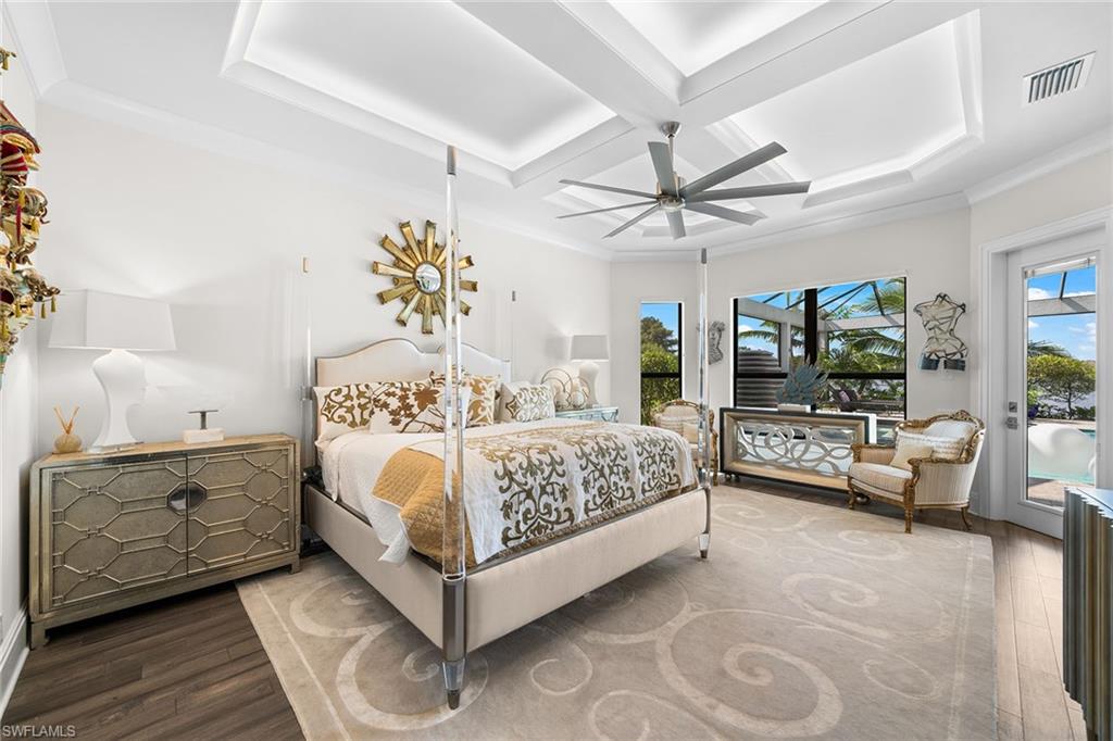 12499 Twin Eagles Boulevard Naples, FL 34120 - Photo 18 of 50 a bedroom with a large bed and a chandelier