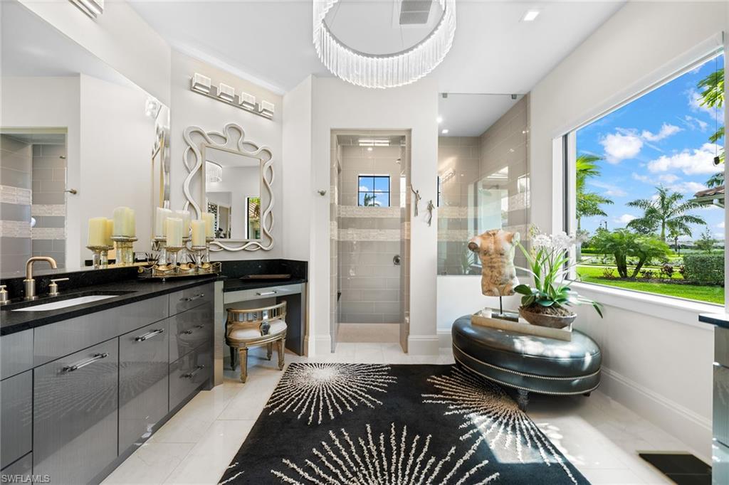 12499 Twin Eagles Boulevard Naples, FL 34120 - Photo 19 of 50 a living room with a couch and a chandelier