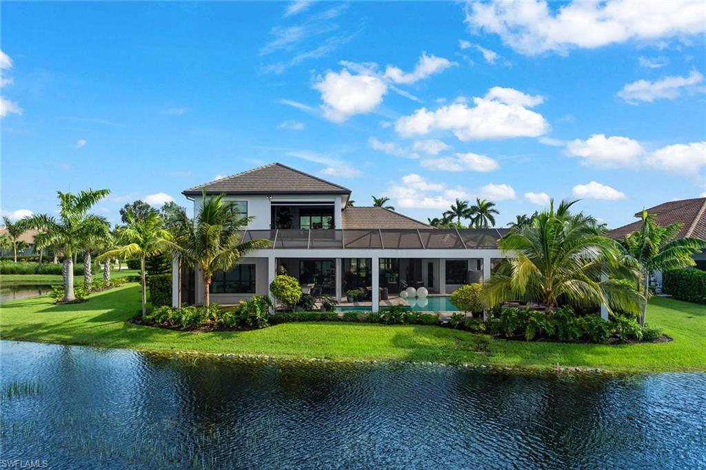 12499 Twin Eagles Boulevard Naples, FL 34120 - Photo 2 of 50 a front view of a house with garden