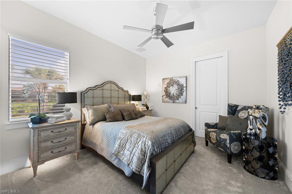 12499 Twin Eagles Boulevard Naples, FL 34120 - Photo 25 of 50 a bedroom with a bed mirror and window