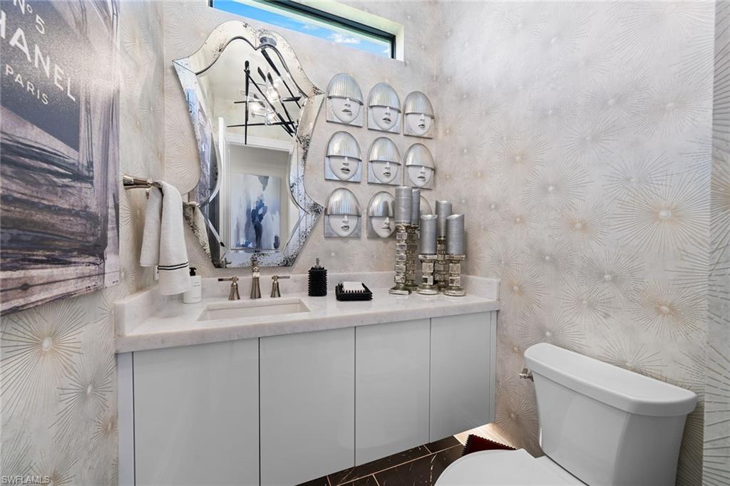 12499 Twin Eagles Boulevard Naples, FL 34120 - Photo 26 of 50 a bathroom with a toilet sink and mirror