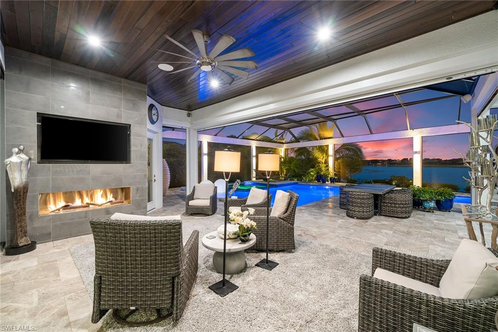12499 Twin Eagles Boulevard Naples, FL 34120 - Photo 39 of 50 a living room with furniture a flat screen tv and a large window