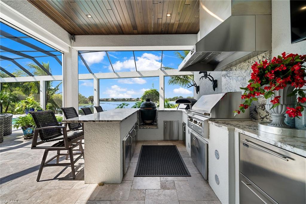 12499 Twin Eagles Boulevard Naples, FL 34120 - Photo 41 of 50 a kitchen with table and chairs