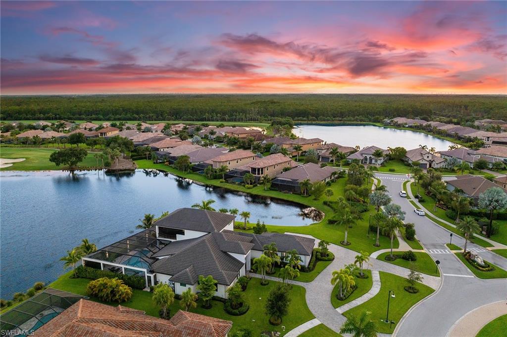 12499 Twin Eagles Boulevard Naples, FL 34120 - Photo 48 of 50 a view of lake and houses with outdoor space