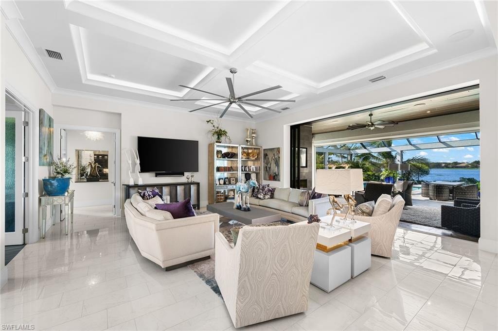 12499 Twin Eagles Boulevard Naples, FL 34120 - Photo 8 of 50 a living room with furniture a flat screen tv and a large window