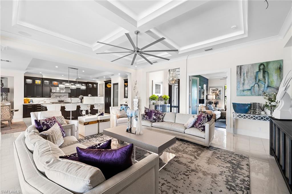 12499 Twin Eagles Boulevard Naples, FL 34120 - Photo 10 of 50 a living room with furniture and a large window with wooden floor