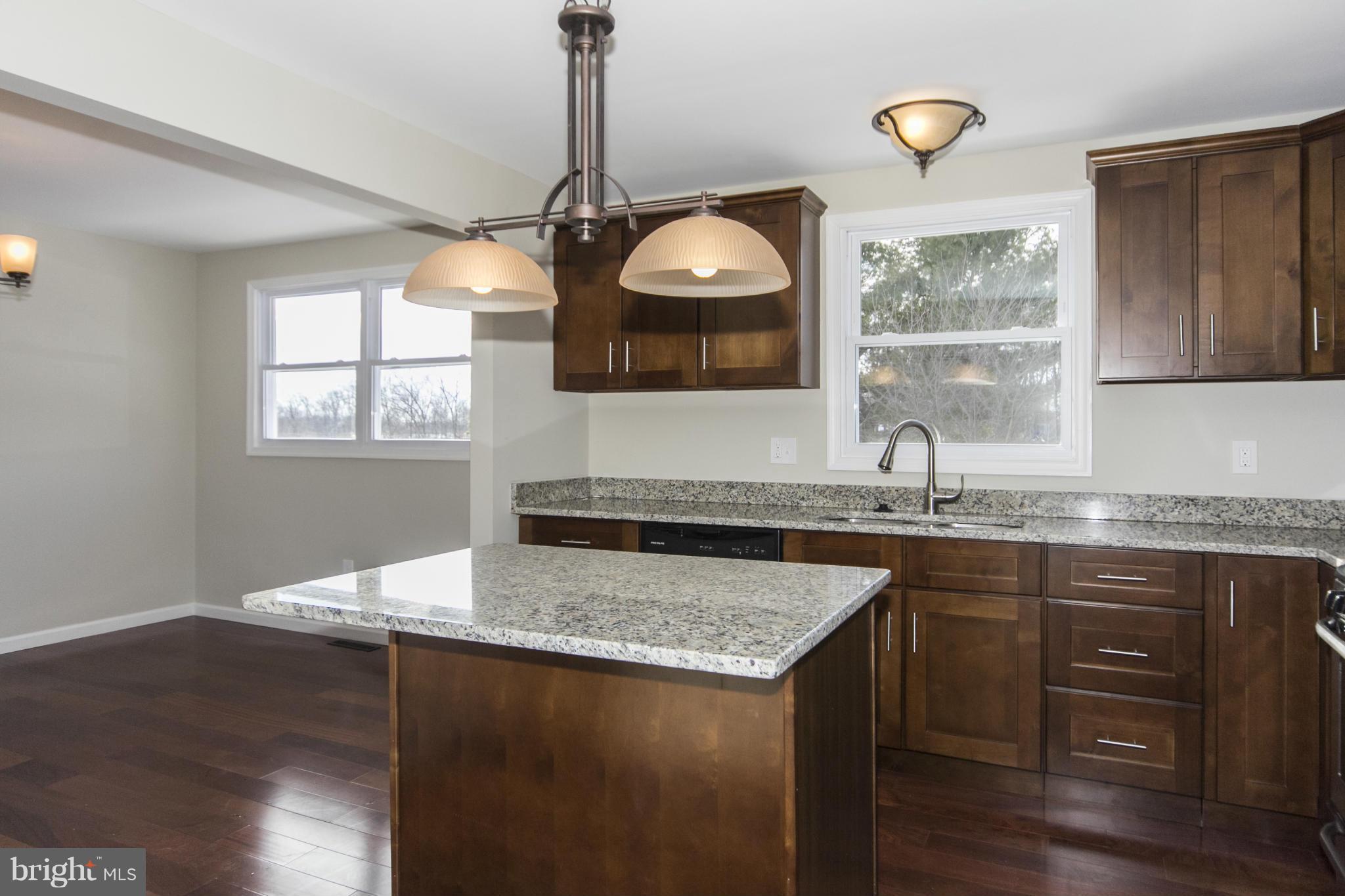 6701 Longhill Road Baltimore, MD 21207 - Photo 1 of 27 a kitchen with sink cabinets and window