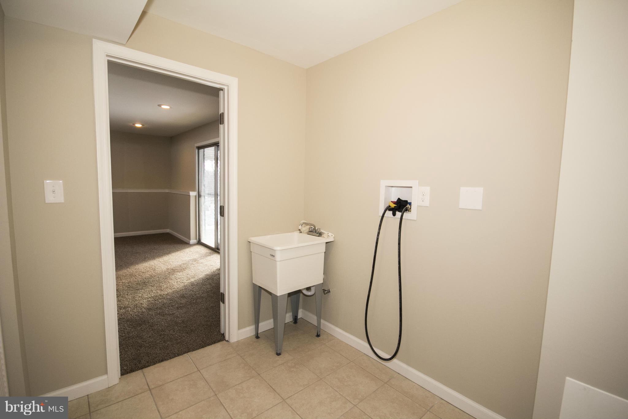 6701 Longhill Road Baltimore, MD 21207 - Photo 23 of 27 a bathroom with a granite countertop shower and a sink