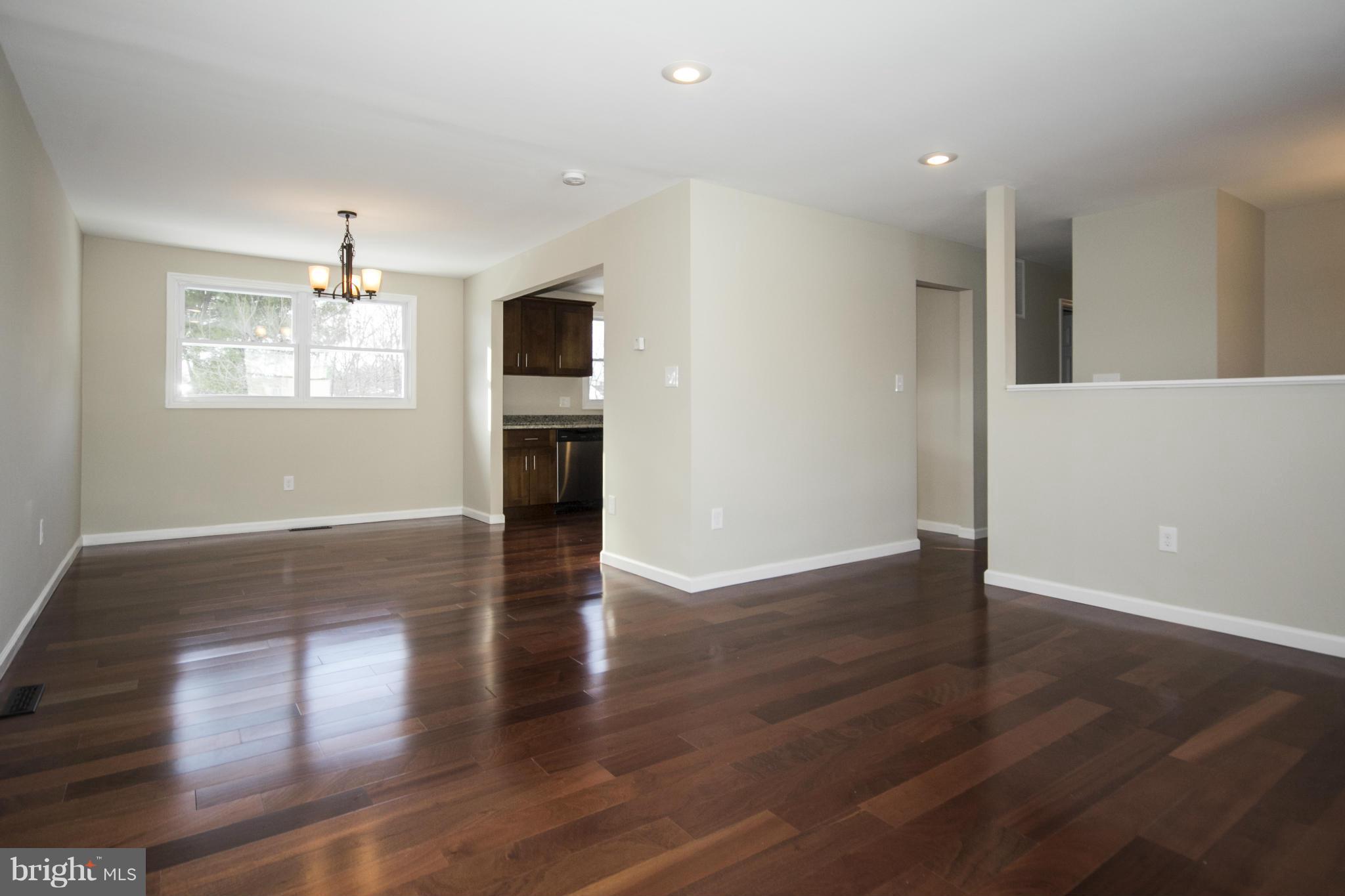 6701 Longhill Road Baltimore, MD 21207 - Photo 8 of 27 an empty room with wooden floor and windows