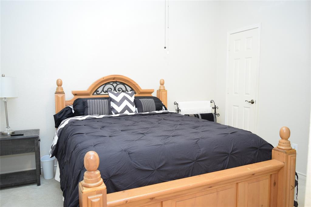 4201 Glistening Spring Rowlett, TX 75088 - Photo 20 of 33 Neutral wall color framing a solid wood bed frame